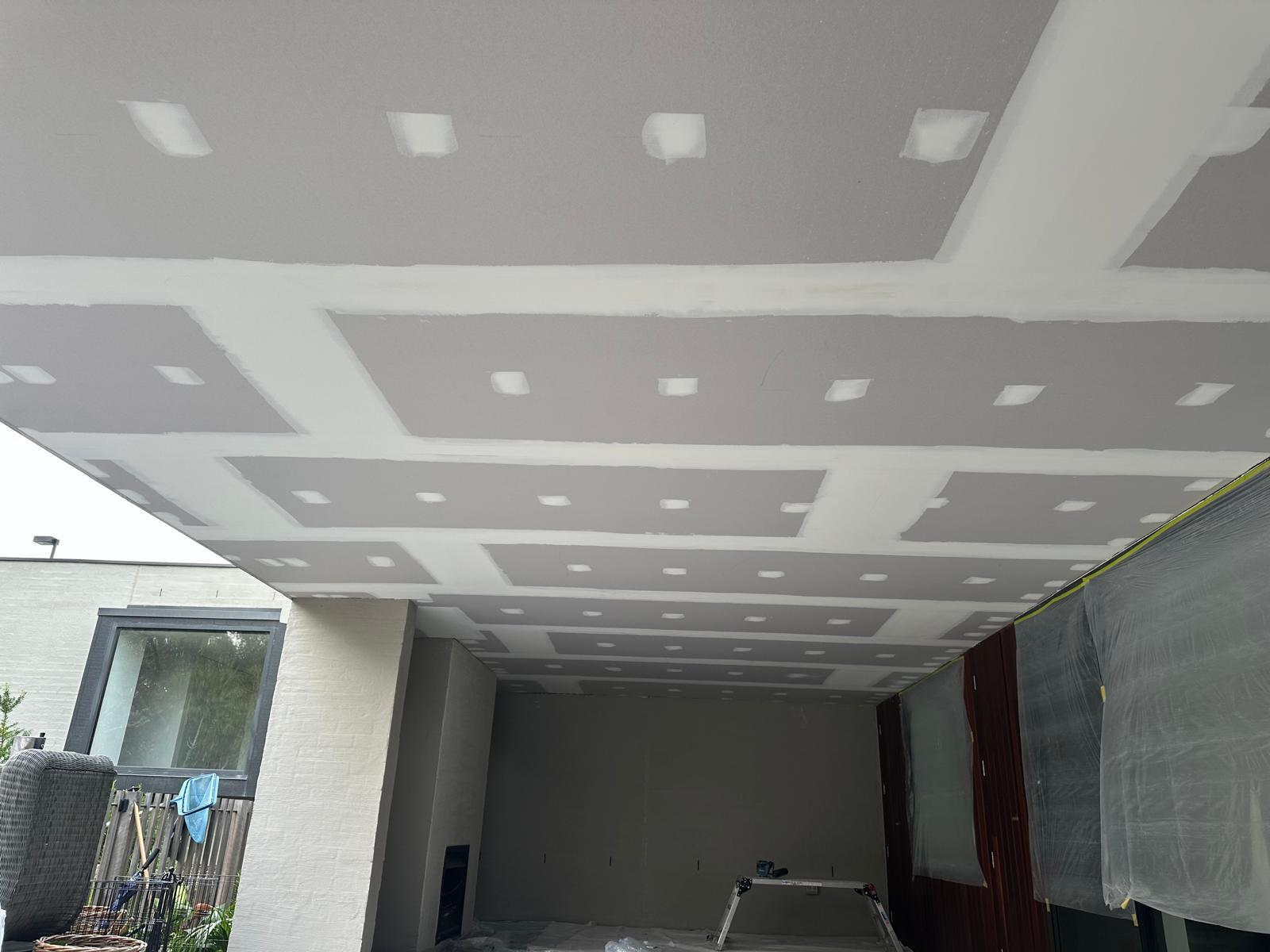 Expertly installed and plastered drywall ceiling, ready for a flawless finish&mdash;perfect for modern renovation projects.